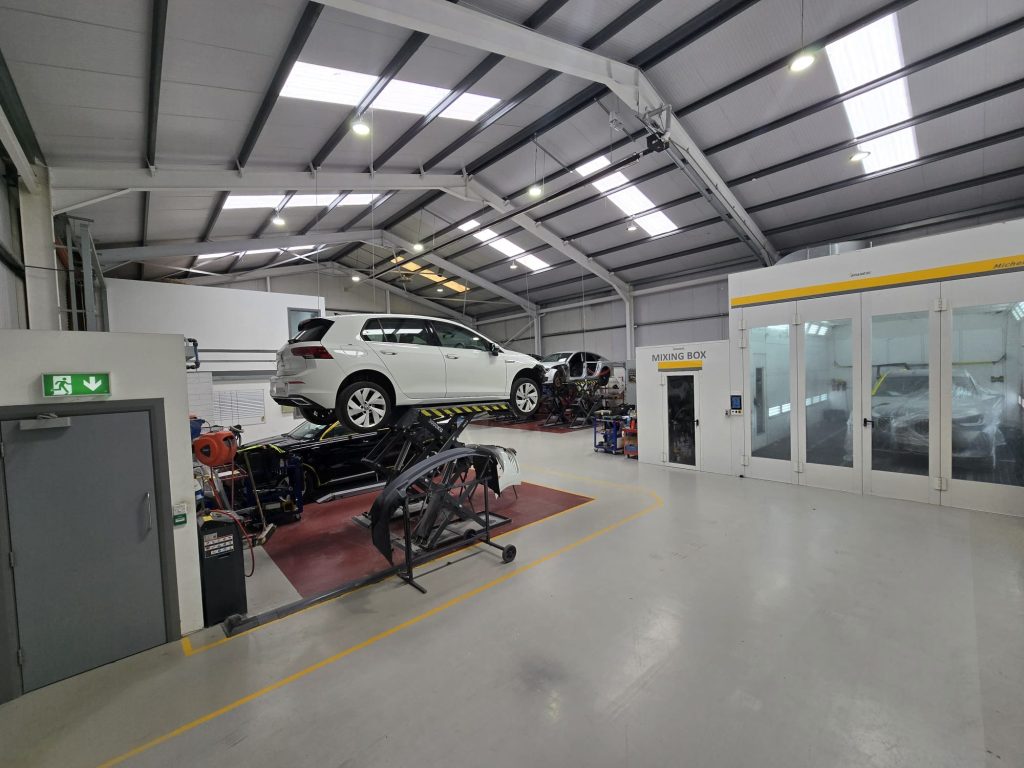 White car in workshop - wide view of interior
