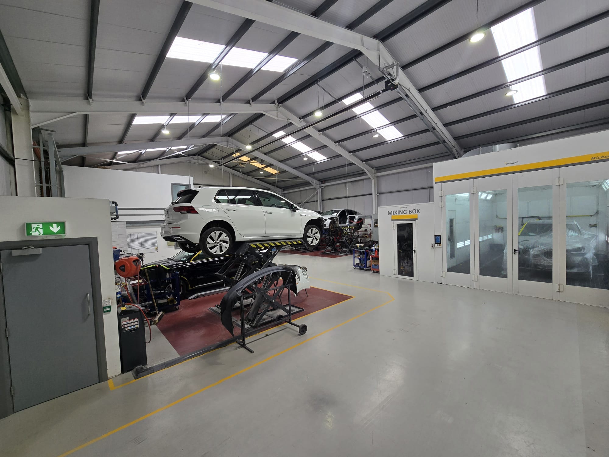 White car in workshop - wide view of interior